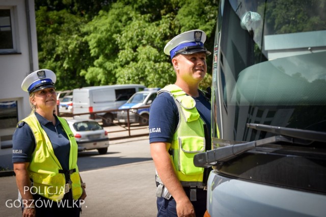 Policjanci oraz inspektorzy transportu drogowego sprawdzają autokary wiozące dzieci i młodzież na letni wypoczynek.