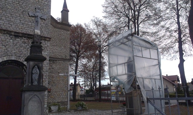 Zabytkowe rzeźby w Żyglinie przed kościołem parafialnym okryte folią