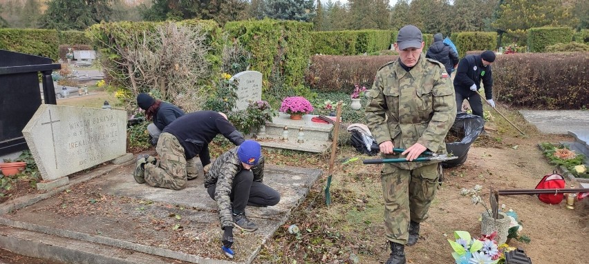 Wolontariusze w czasie porządkowania opuszczonego grobu...