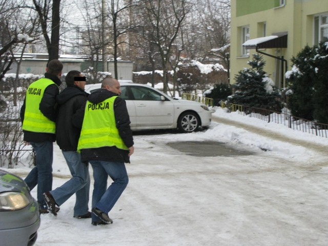 Na zdjęciu Grzegorz O. prowadzony przez policjantów na wizję lokalną