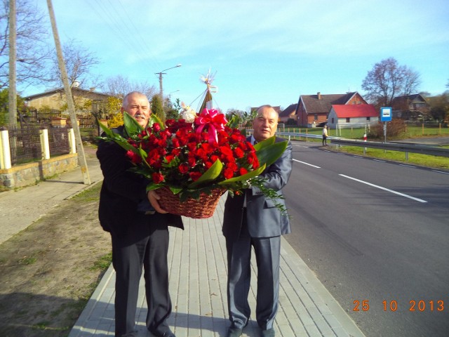 Radny Piotr Milda i przedsiębiorca Bolesław Prondziński z kwiatami dla jubilatki
