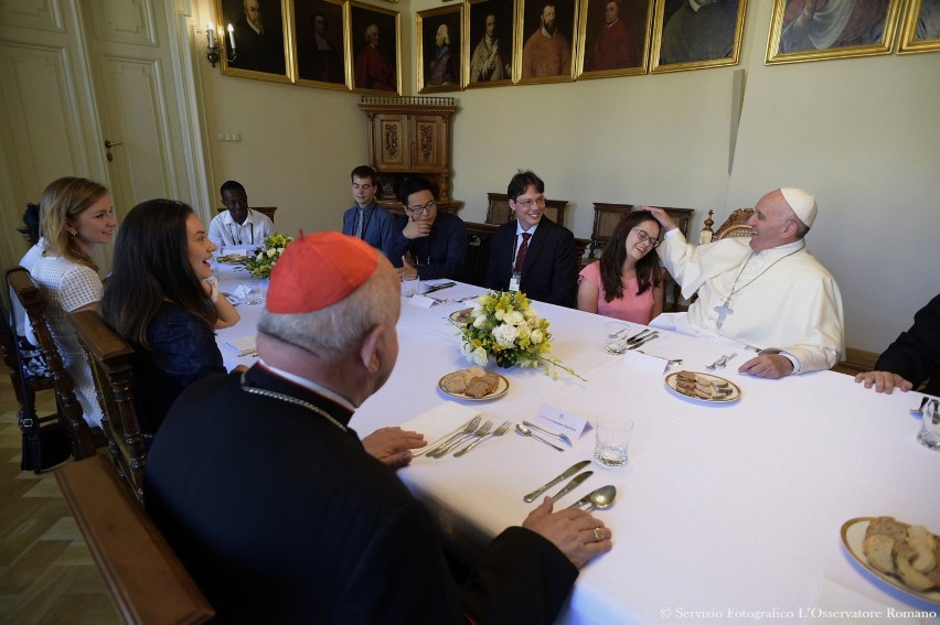 Pope francis, top right, has lunch with 12 youths at the...