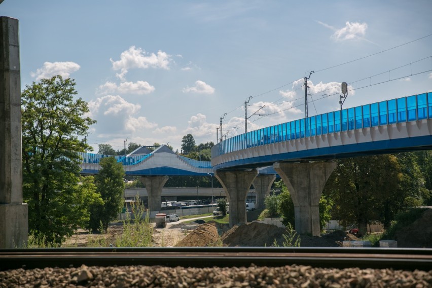 Niebieskie ekrany akustyczne wzdłuż estakady kolejowej są...