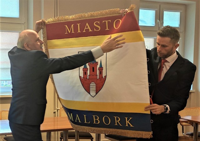 Sztandar dla Malborka prezentuje Bogdan Mąder, szef komitetu fundacyjnego i Paweł Dziwosz, przewodniczący Rady Miasta.