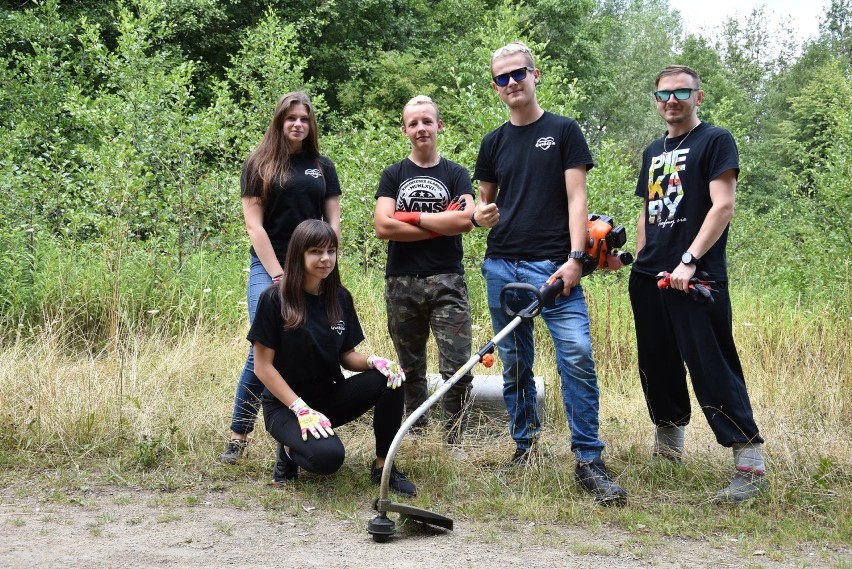 Wolontariusze Gwoździa koszą trawniki w Piekarach Śląskich....