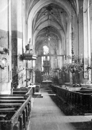 Nawa główna z ołtarzem i belką tęczową. Ambona widoczna po lewej stronie znajduje się dziś w kościele Mariackim.	Rep. Robert Kwiatek, własność Nadbałtyckiego Centrum Kultury