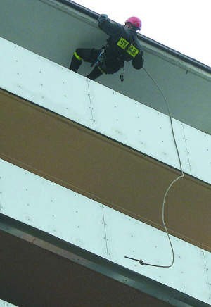 Kapitan Wojciech Piechaczek z dachu został opuszczony na balkon mieszkania poszkodowanej kobiety.
