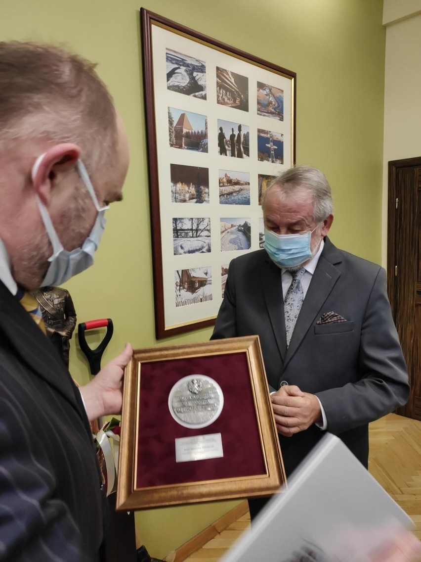 Marszałek Piotr Całbecki Przekazuje medal synowi pani Anieli...