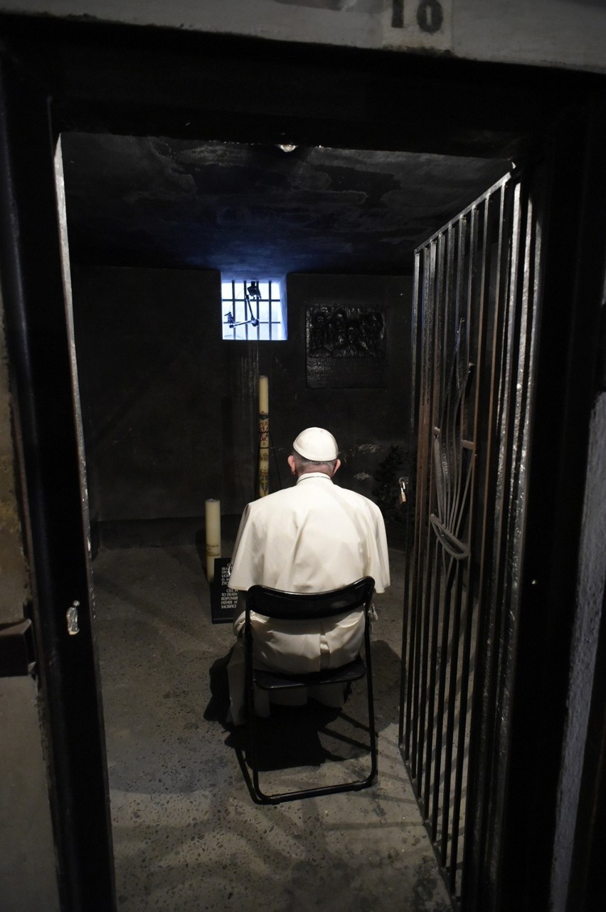 Pope francis prays in the underground prison cell of a...