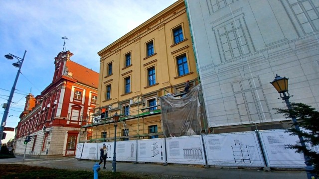 Częściowo widoczna nowa elewacja budynku u zbiegu Grodzkiej i Szewskiej oraz wizualizacje obiektu i jego wnętrz