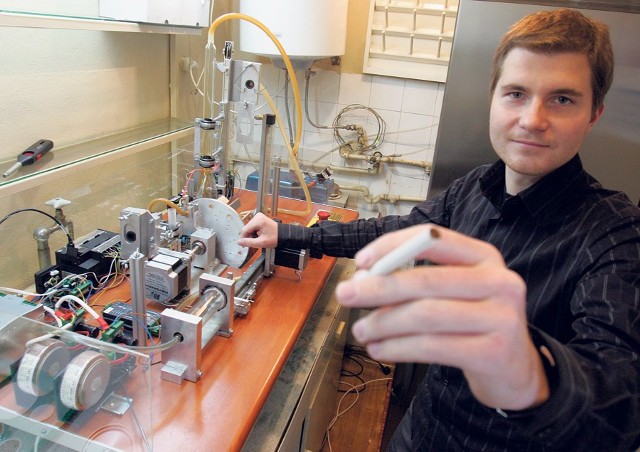 Bartosz Koszowski przy maszynie do badania powietrza w pubach