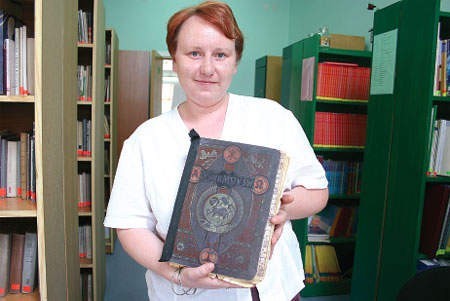 Marta Panek, która opiekuje się zbiorem starych książek w szkolnej bibliotece i księga &amp;#8222;Ofiara mszy Świętej w tajemnicach i cudach...&amp;#8221;.