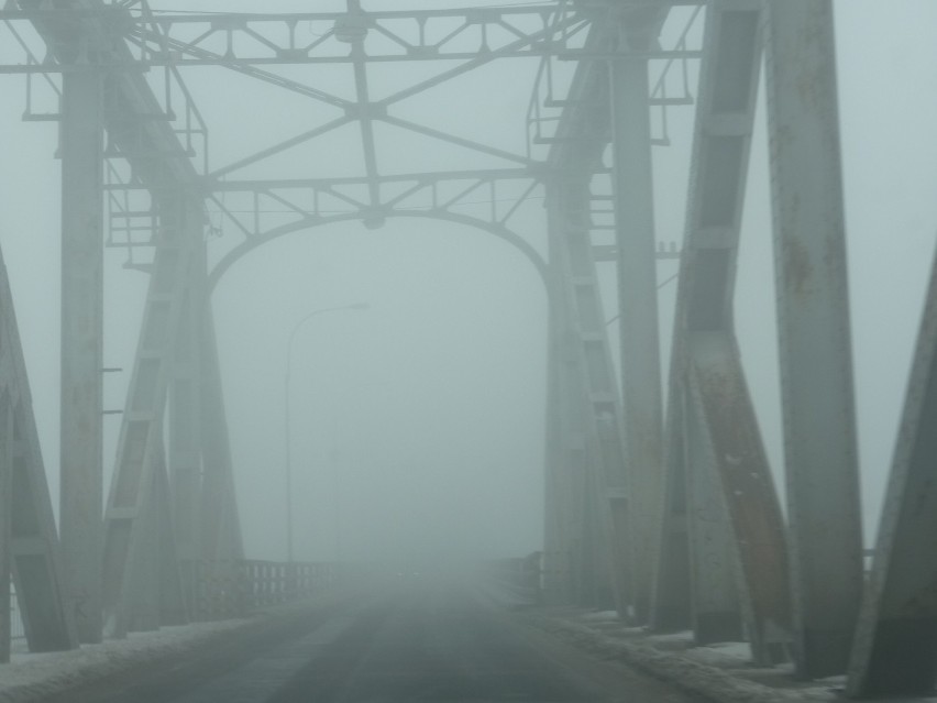 Gęsta mgła utrudnia jazdę. Policjanci kierują ruchem na moście przez Wisłę